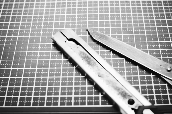 Tools on cutting mat black and white color tone style — Stock Photo, Image