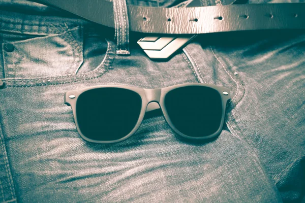 Sunglasses on jean pants retro vintage style — Stock Photo, Image