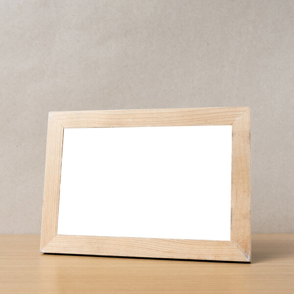 Picture frame on wood table background