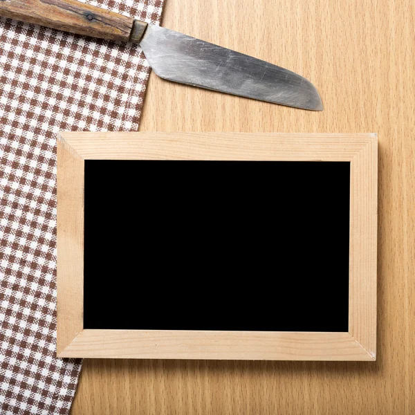 Blackboard and knife on towel — Stock Photo, Image