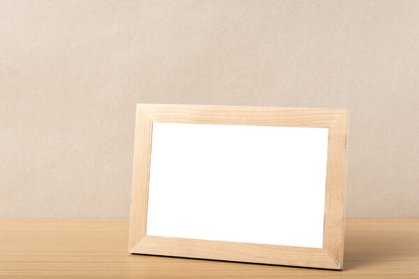 Picture frame on wood table background
