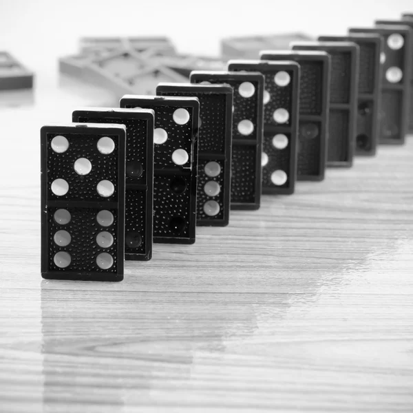 Black domino on wooden background — Stock Photo, Image