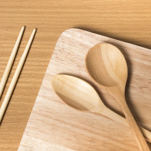 Wood spoon with cutting board — Stock Photo, Image
