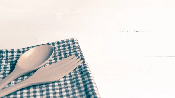 Wood spoon and fork on kitchen towel vintage style — Stock Photo, Image