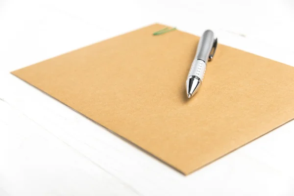 Brown paper with pen — Stock Photo, Image