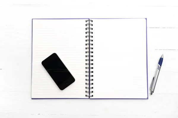 Telefone inteligente no bloco de notas — Fotografia de Stock
