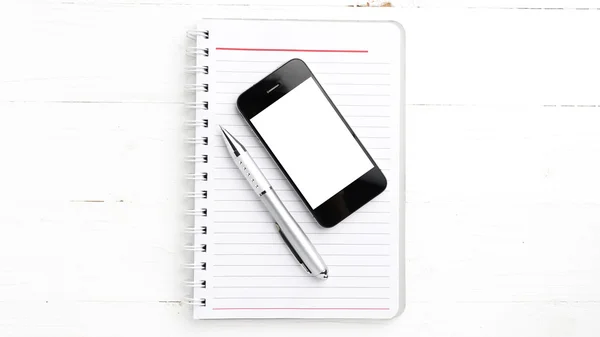 Bloco de notas e celular — Fotografia de Stock