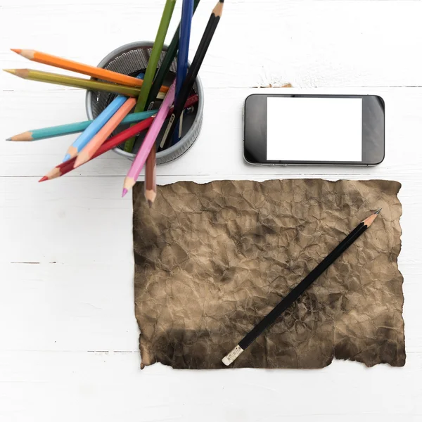 Burning brown paer with smart phone and pencil — Stock Photo, Image