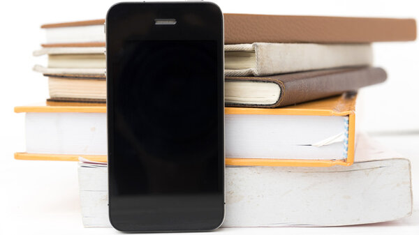 cellphone with stack of book