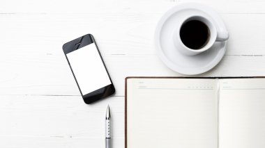cep telefonu ile defter ve kahve Kupası