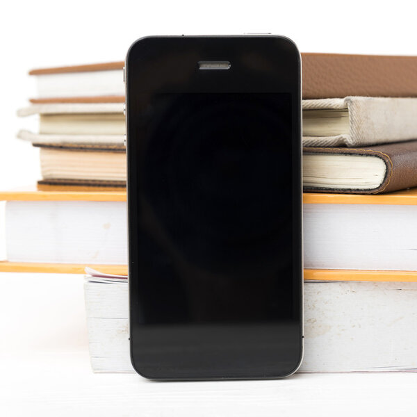 cellphone with stack of book