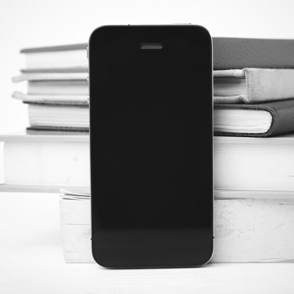 cellphone with stack of book black and white tone color style