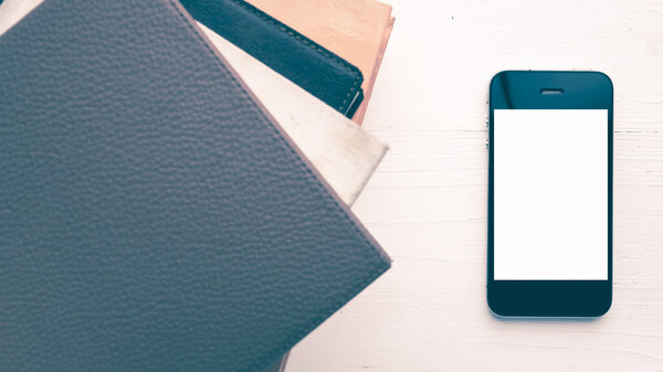 cellphone with stack of book vintage style