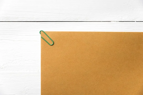 Brown paper with green paper clip — Stock Photo, Image