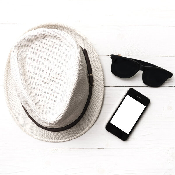 hat sunglasses and smart phone