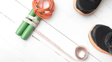 Beyaz ahşap masa üzerinde fitness ekipmanları