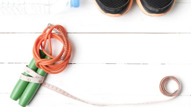 Beyaz ahşap masa üzerinde fitness ekipmanları