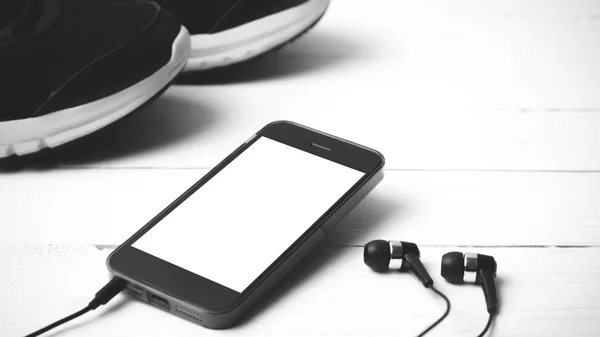 running shoes and phone black and white tone color style