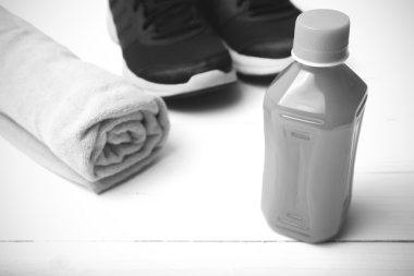 running shoes,towel and orange juice black and white tone color 