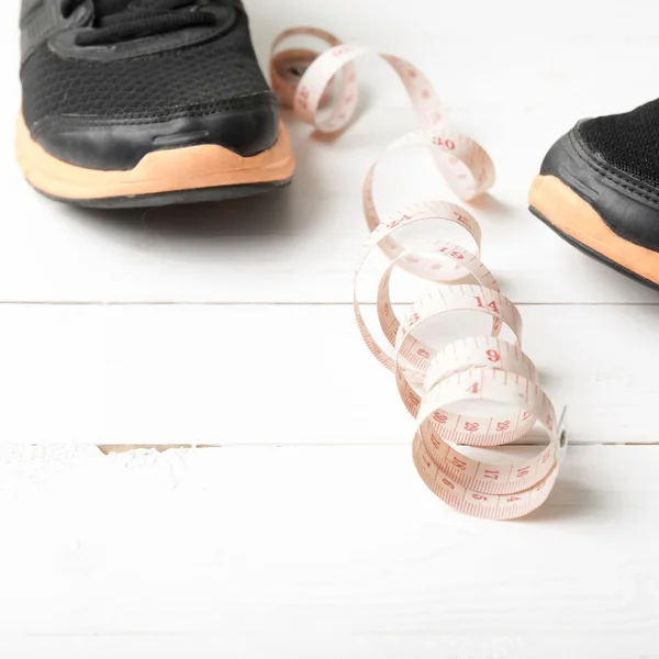 Running shoes and measuring tape — Stock Photo, Image