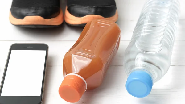 Running shoes,orange juice,drinking water and phone — Stock Photo, Image