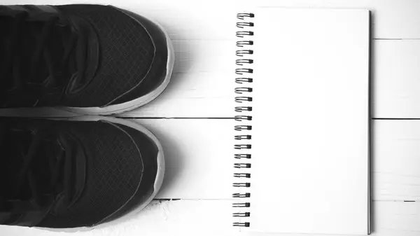 Zapatillas de running y bloc de notas estilo de color blanco y negro —  Fotos de Stock