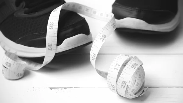 Running shoes and measuring tape black and white tone color styl — Stock Photo, Image