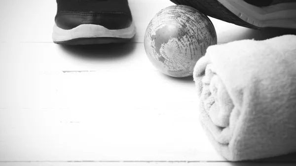 Running shoes,earth ball and towel black and white tone color st — Φωτογραφία Αρχείου