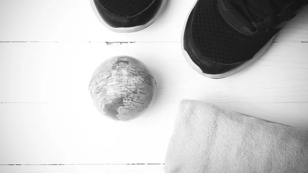 Running shoes,earth ball and towel black and white tone color st — ストック写真