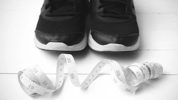 Running shoes and measuring tape black and white tone color styl — Stok fotoğraf