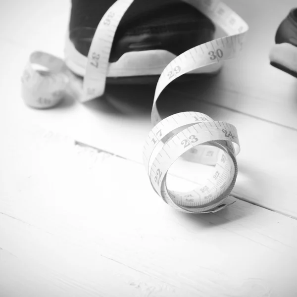 Running shoes and measuring tape black and white tone color styl — ストック写真