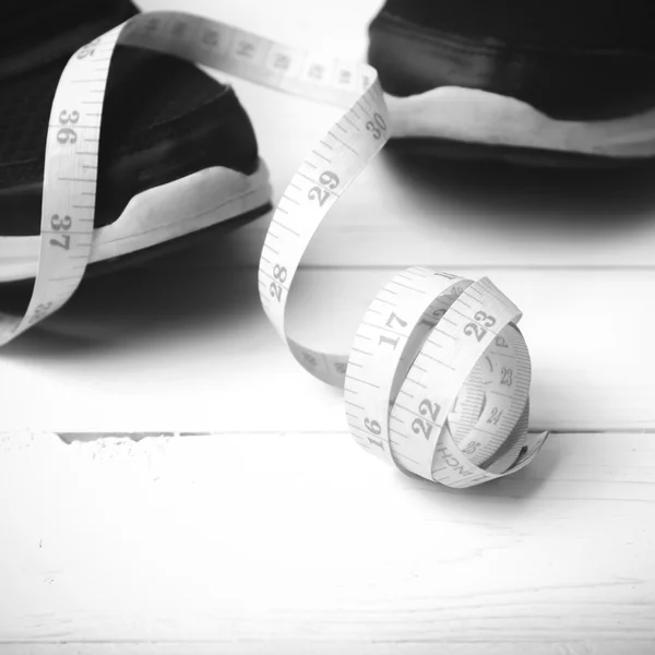 Running shoes and measuring tape black and white tone color styl — Zdjęcie stockowe