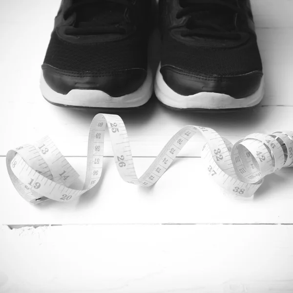 Running shoes and measuring tape black and white tone color styl — 图库照片