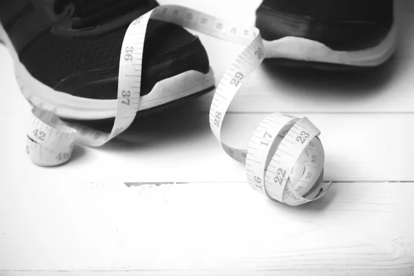 Running shoes and measuring tape black and white tone color styl — Stock Photo, Image