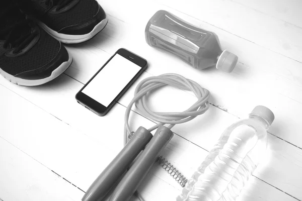 fitness equipment on white wood background black and white color