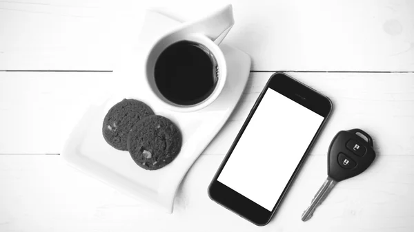 Coffee cup with cookie,phone and car key black and white color — Stock Photo, Image