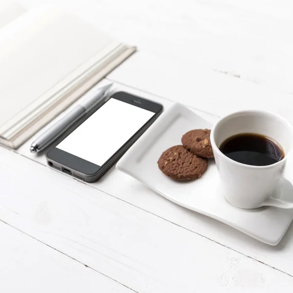 Coffee cup with cookie,phone with notebook and pen — Stock Photo, Image