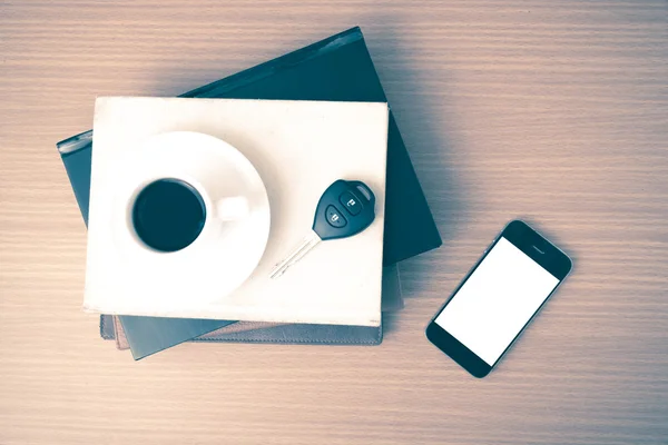 Coffee cup with phone car key and stack of book — Stock Photo, Image