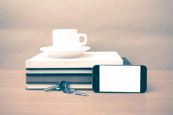 Kaffeetasse mit Telefonschlüssel und Stapel Buch — Stockfoto