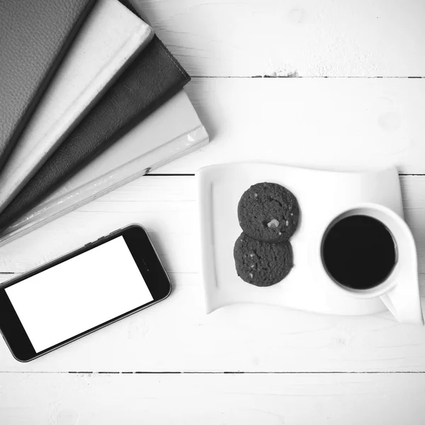 Coffe cup with cookie,phone and stack of book black and white co — Stock Photo, Image