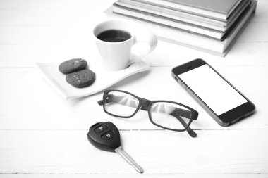 Kahve Kupası ile tanımlama bilgisi, telefon, araba anahtarı, gözlük ve kitap yığını