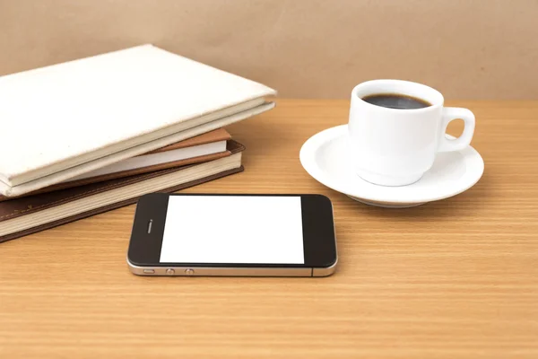 coffee cup and phone and stack of book