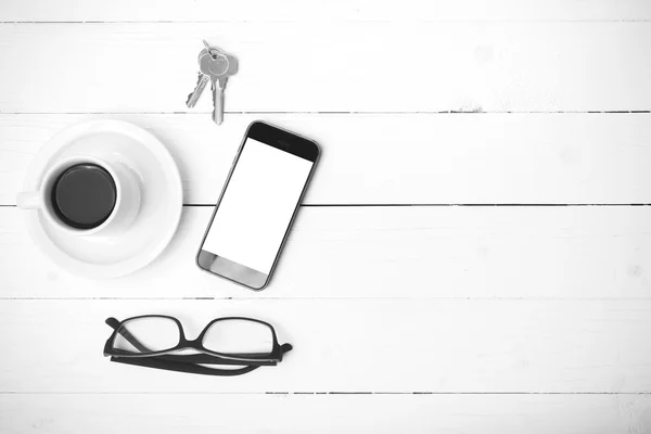 Coffee cup with phone, eyeglasses and key black and white color — Stock Photo, Image