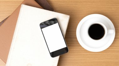 kahve fincanı ve telefon ve kitap yığını