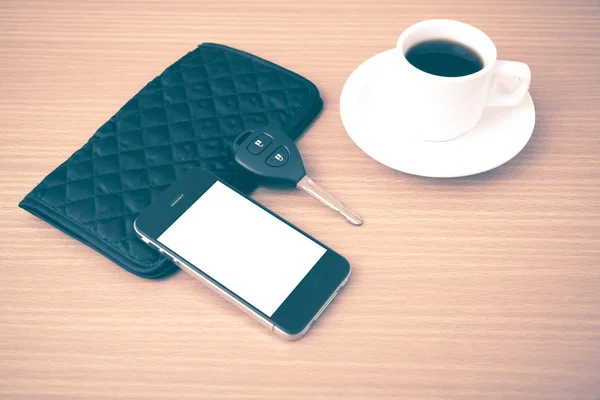 Koffiekopje met telefoon auto sleutel en portefeuille — Stockfoto