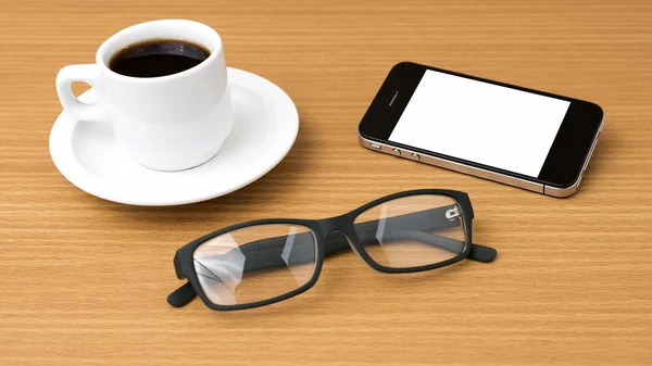 Tazza di caffè e telefono e occhiali da vista — Foto Stock