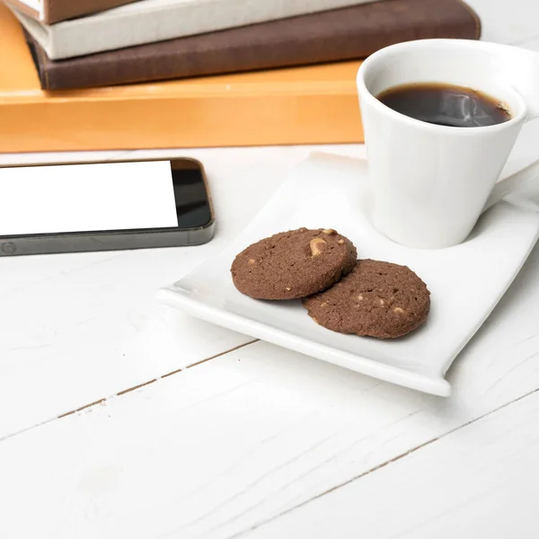 Coffe cup with cookie,phone and stack of book — Stock Photo, Image