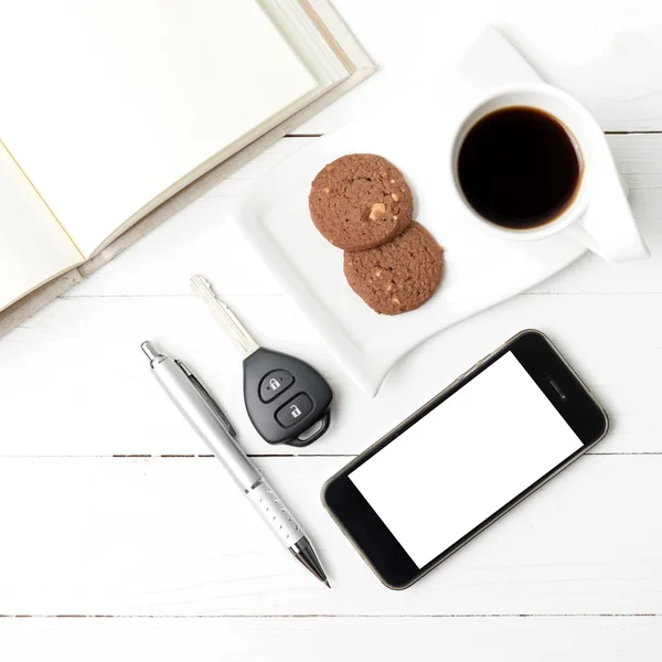 Чашка кави з печивом, телефоном, відкритим записником та ключем автомобіля — стокове фото