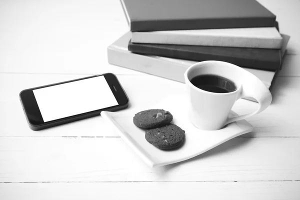 Coffe cup with cookie,phone and stack of book black and white co — Stock Photo, Image
