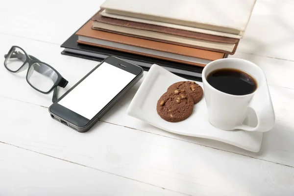 Coffee cup with cookie,phone,stack of book and eyeglasses — Stock Photo, Image